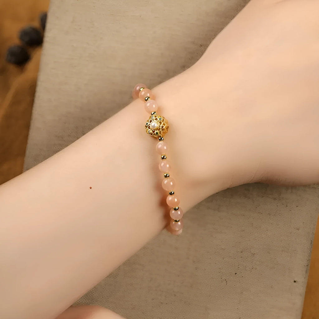 Hand-woven crystal bracelet with gray moonstone, sunstone, and strawberry quartz beads in pastoral style.