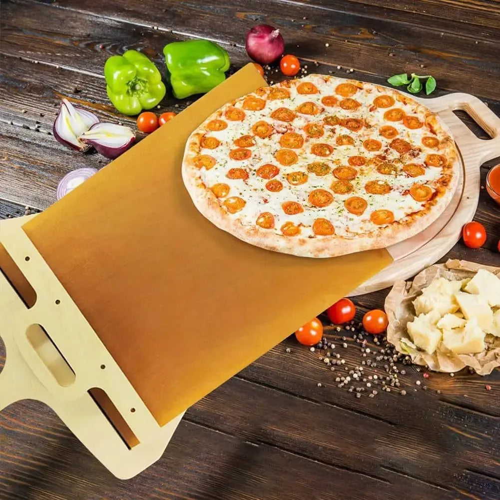White plastic pizza transfer shovel on a kitchen counter, showing its flat board surface and handle with hanging hole.
