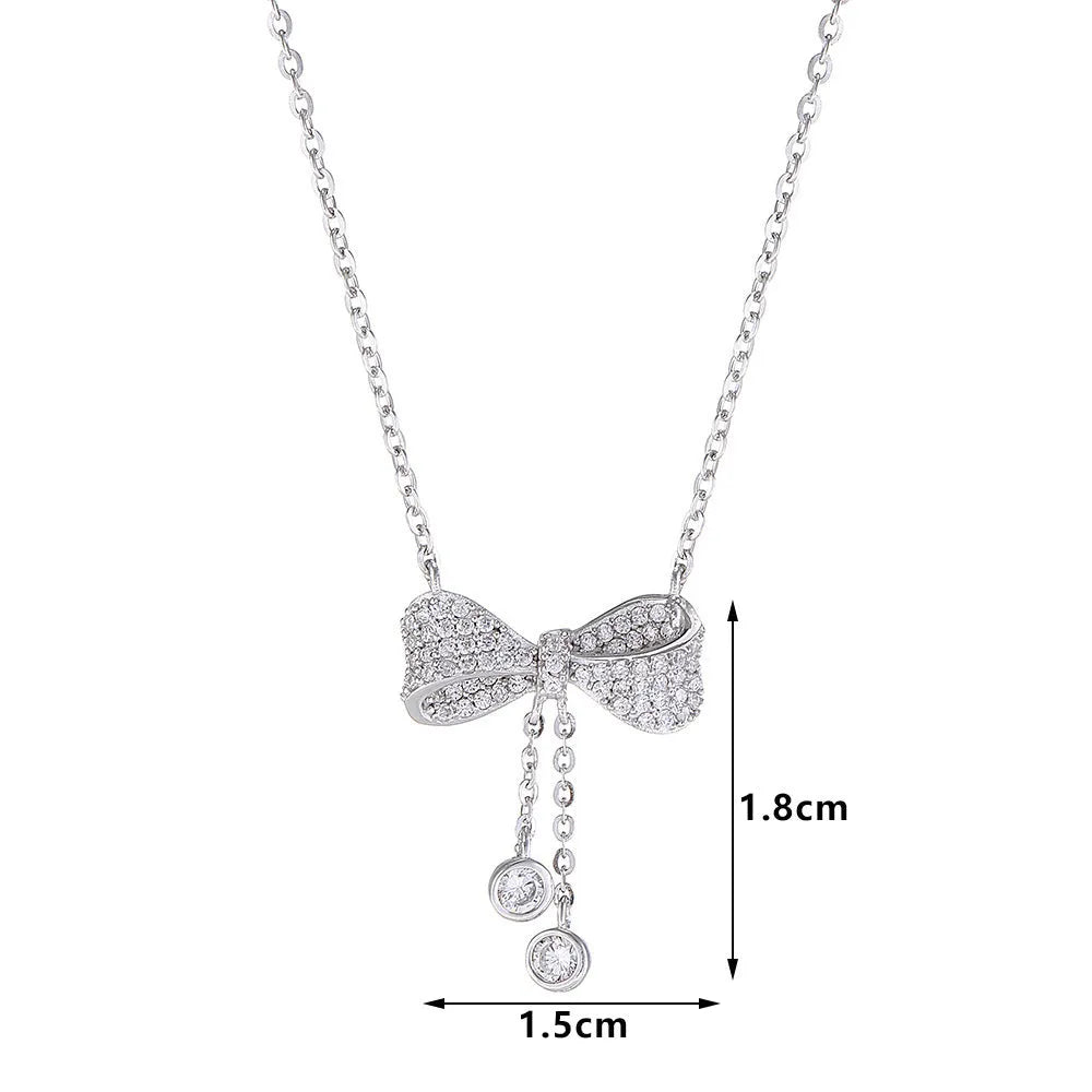 S925 sterling silver bow necklace on collarbone, showing O-ring chain and detailed bow pendant