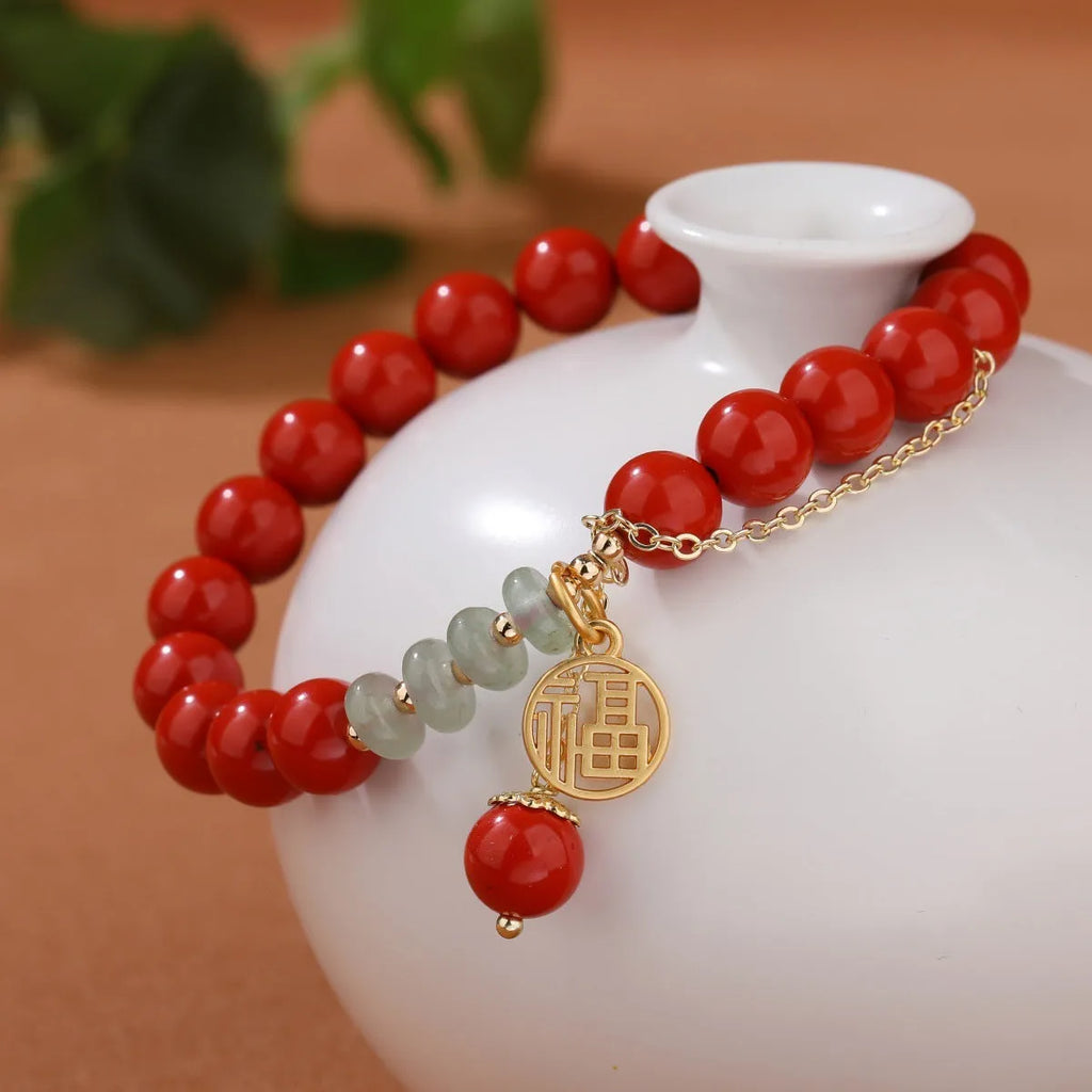 Women's red sand cinnabar bracelet with fu character charm and jade spacer