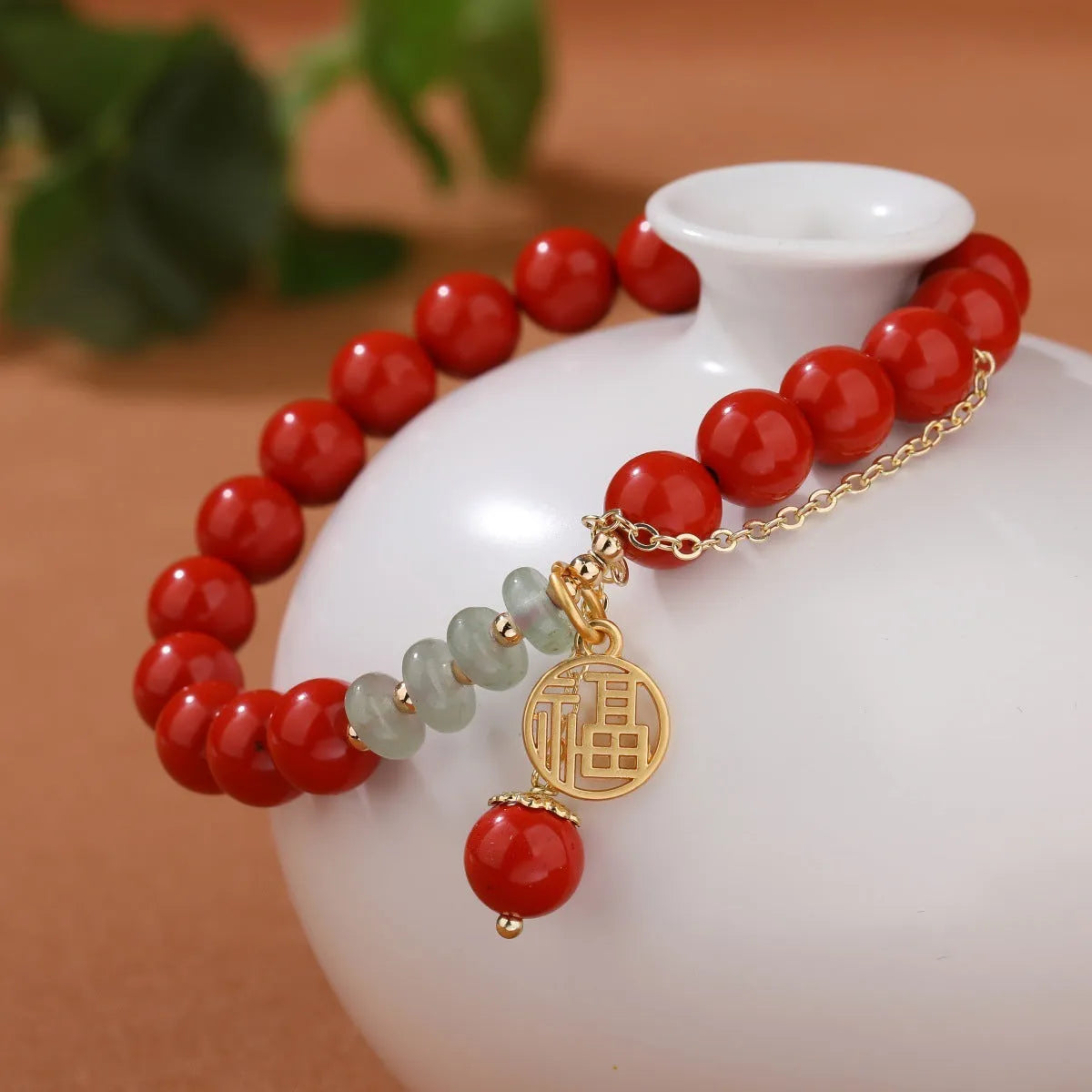 Women's red sand cinnabar bracelet with fu character charm and jade spacer