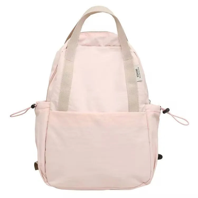 Solid colour nylon backpack in blue with curved straps and a lock, shown in a travel setting.