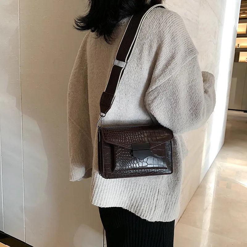 Vintage PU leather crossbody bag shown in black, dimensions 20cm by 14cm.