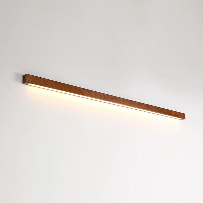 Modern wooden log strip wall lamp mounted on a wall in walnut colour