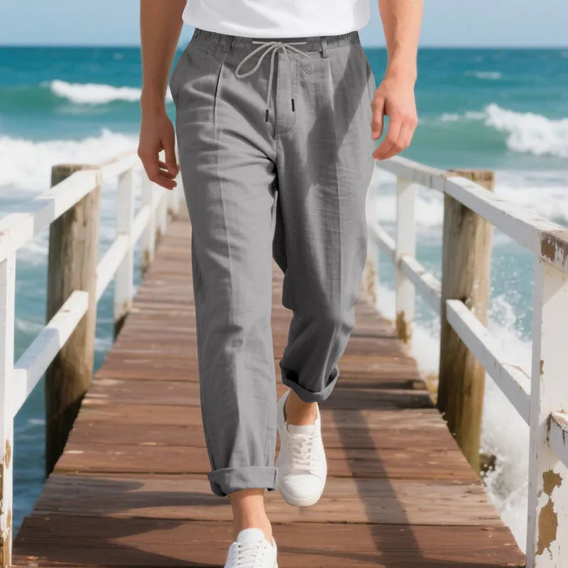 Men's light khaki linen casual trousers with drawstring waist on a hanger.