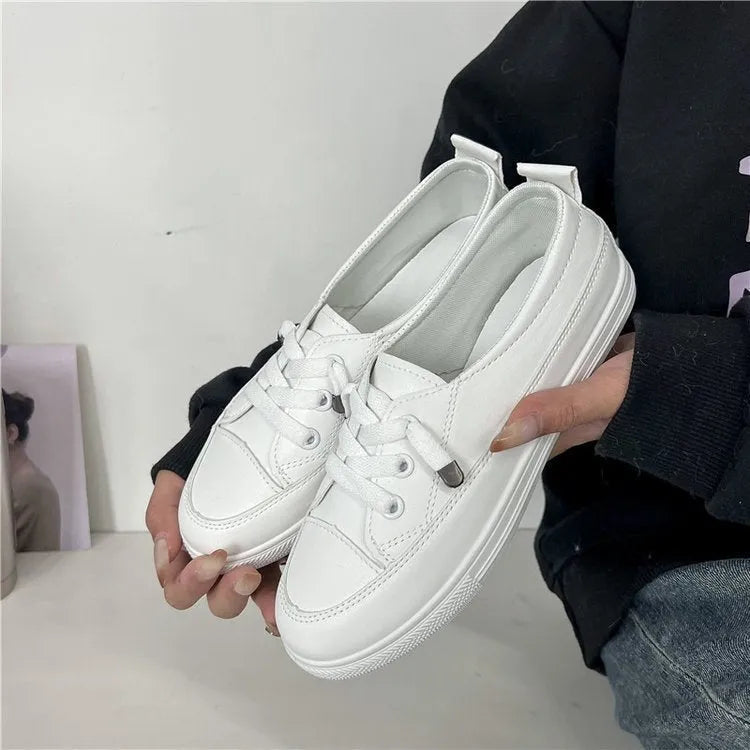 White women's sports breathable shoes with patent leather upper, flat heel, round toe, and front lace-up on a plain background