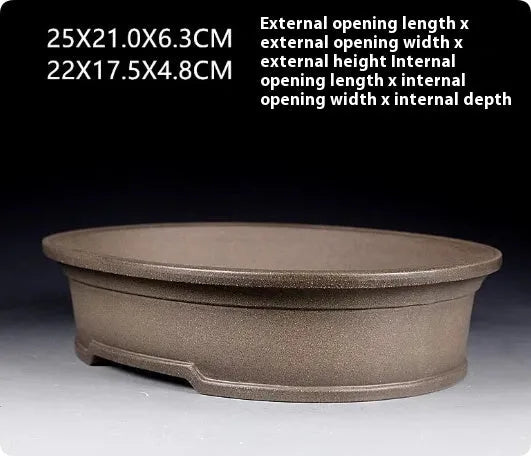 Handmade antique oval bonsai flower pot made from purple sand clay, dimensions 25x21x6.3 cm.