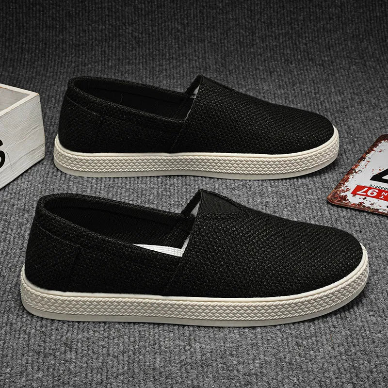 Men's beige canvas casual shoes with round toe and shallow cut, shown on a white background.