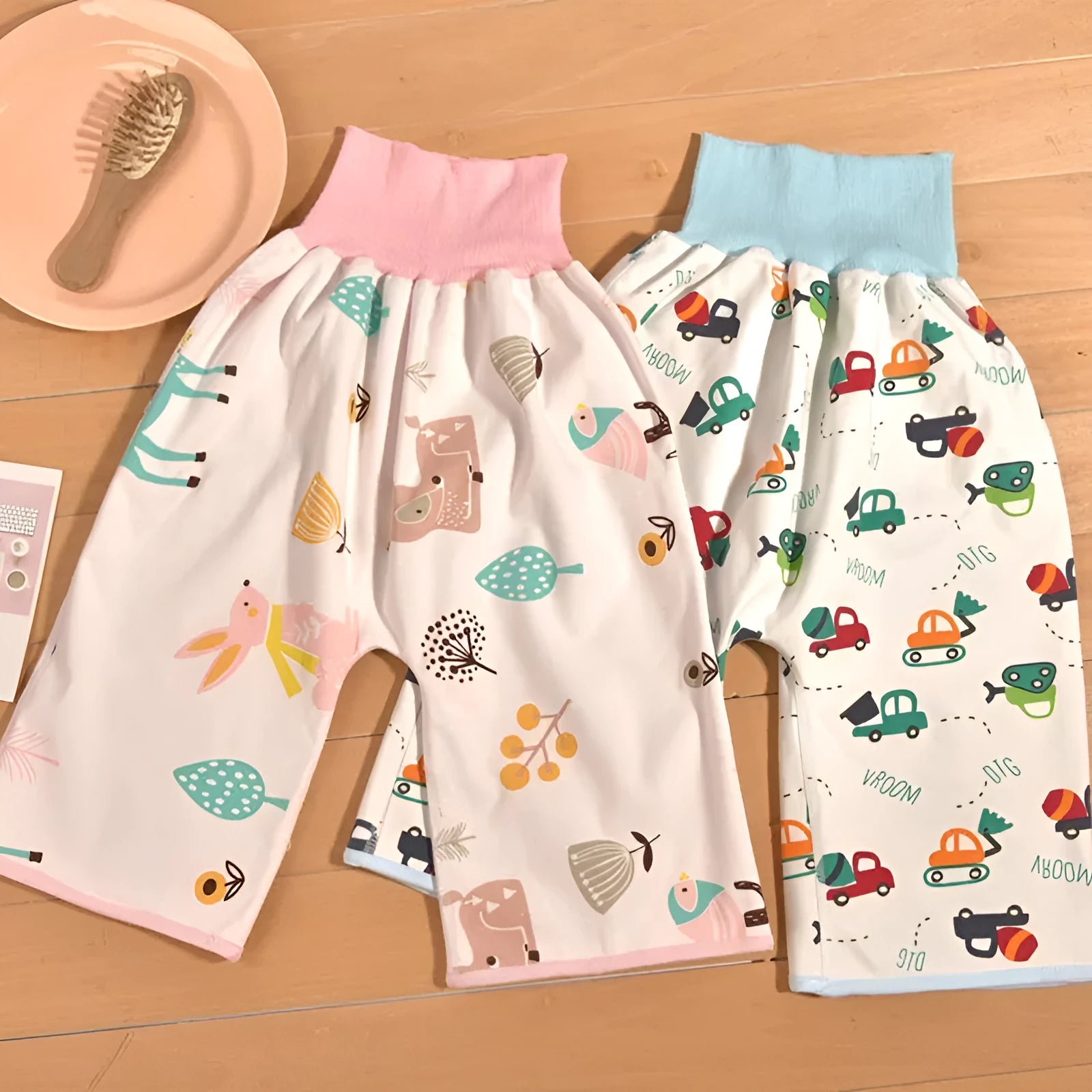 High waist baby diaper training pants in blue car cartoon print, showing elastic waistband.