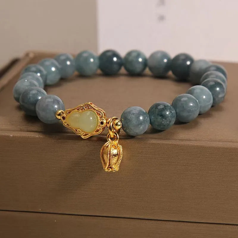 Sky blue natural stone gourd lotus pendant on a women's electroplated bracelet.
