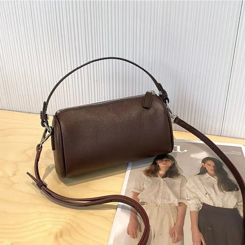 Genuine leather mobile phone crossbody bag with cylindrical design in six colour options showing sewing thread detailing
