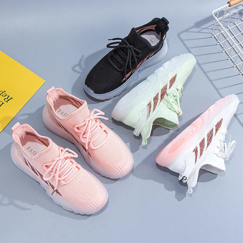Women's white cowhide leather sports casual shoes with flat heel and round toe on a light background.