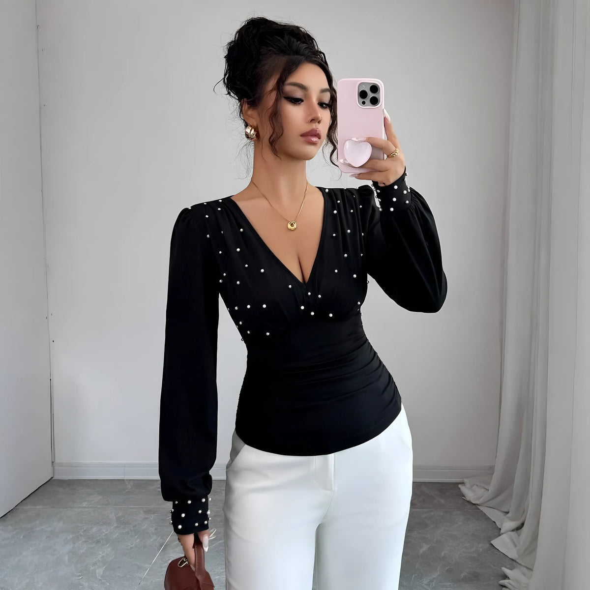 Women's V-neck solid colour fitted t-shirt with long bell sleeves in black, wine red, or apricot.