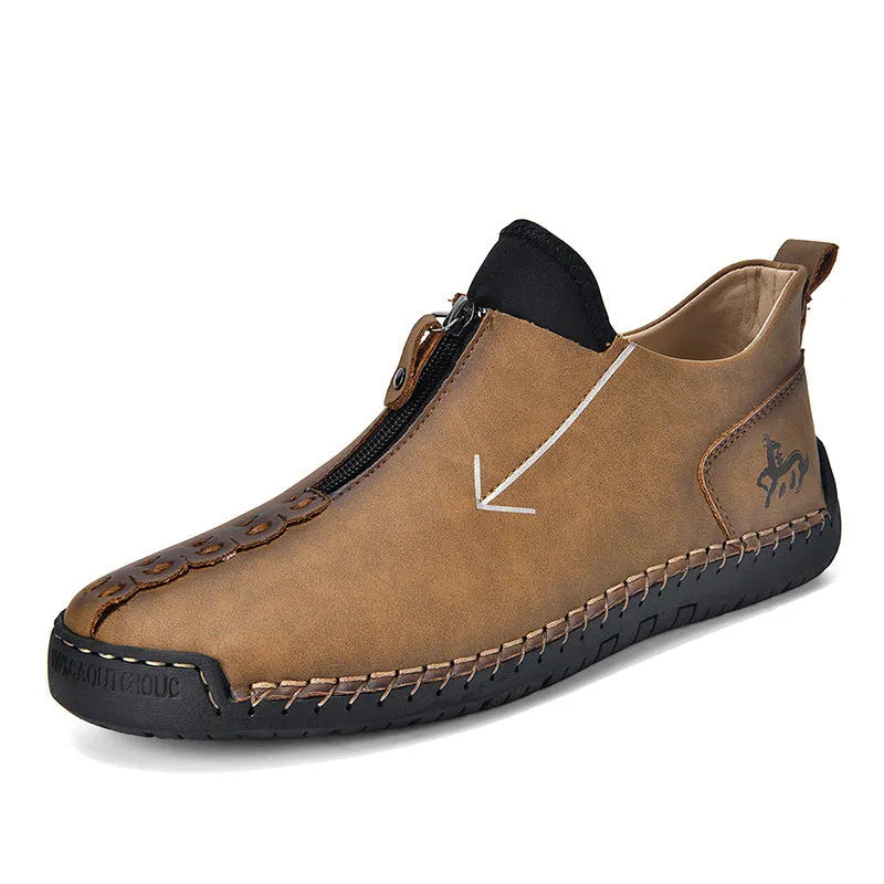 Men's black leather ankle boots with a front zipper and hand-stitched rubber sole.