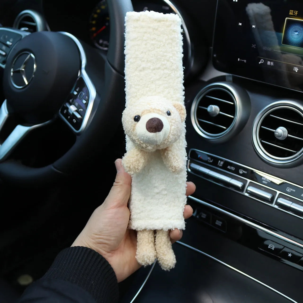 Cartoon plush lamb wool seat belt shoulder protector cover in Bear design on a car seat.