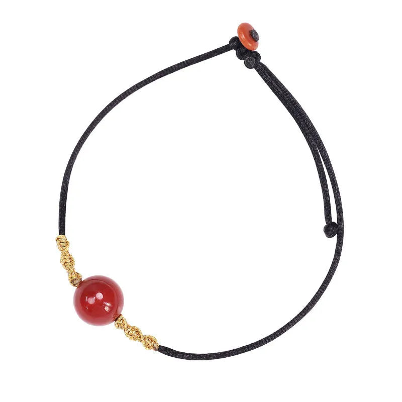 A natural red agate bead bracelet and necklace set with hand-woven detailing.