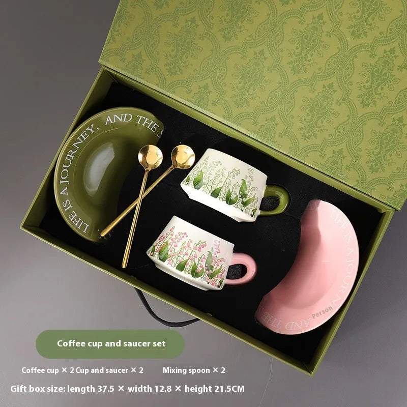 Ceramic coffee cup and saucer set with two mugs, two saucers and two stirring spoons
