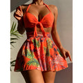 Printed three-piece polyester beach dress bikini set with skirt in orange, shown on model