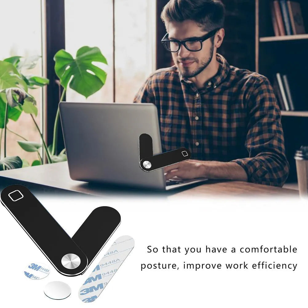 Black aluminium magnetic phone holder clipped to side of a silver laptop.
