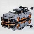 Cement gray sports car assembled building block toy model of a lying Porsche on a flat surface