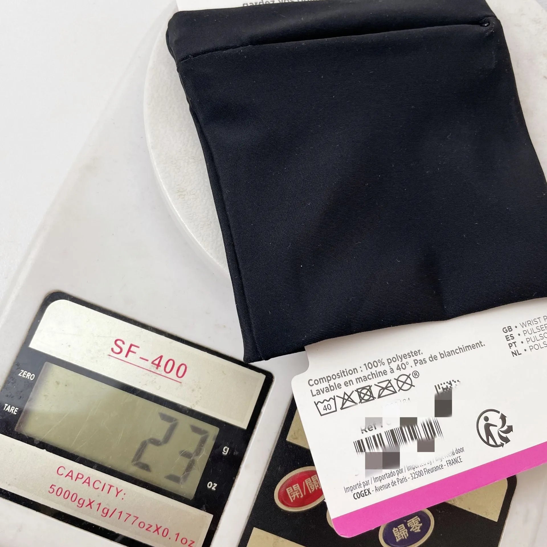 Wrist bag armband sleeve showing 10cm by 10.5cm phone compartment and protective packaging.