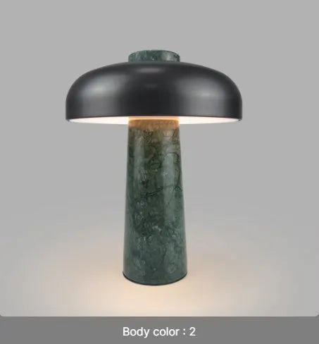 Modern alloy desk lamp with a rechargeable battery and touch-sensitive dimming switch on a wooden desk