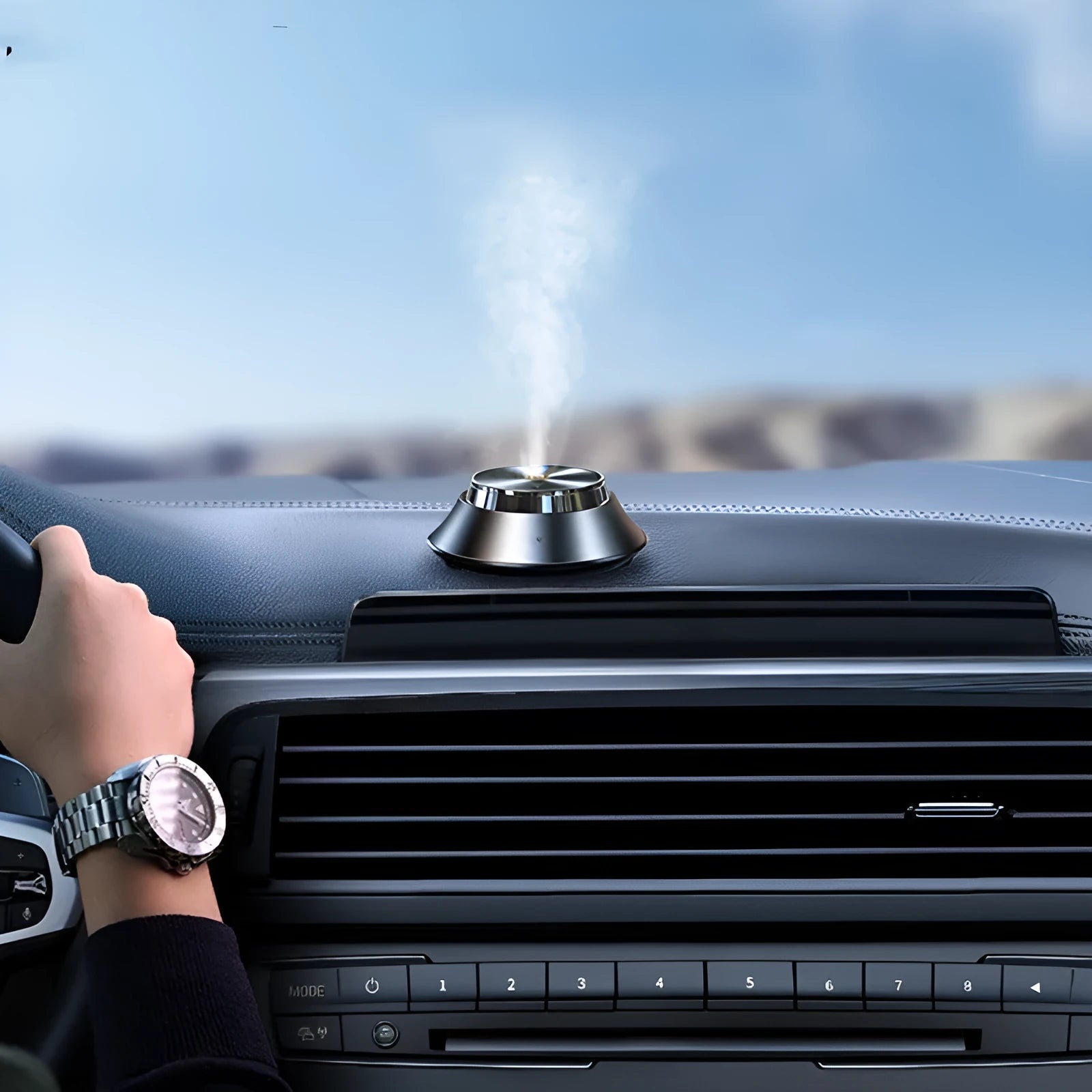 Black metal butterfly-style car aromatherapy machine with USB cable and bottle of essential oil