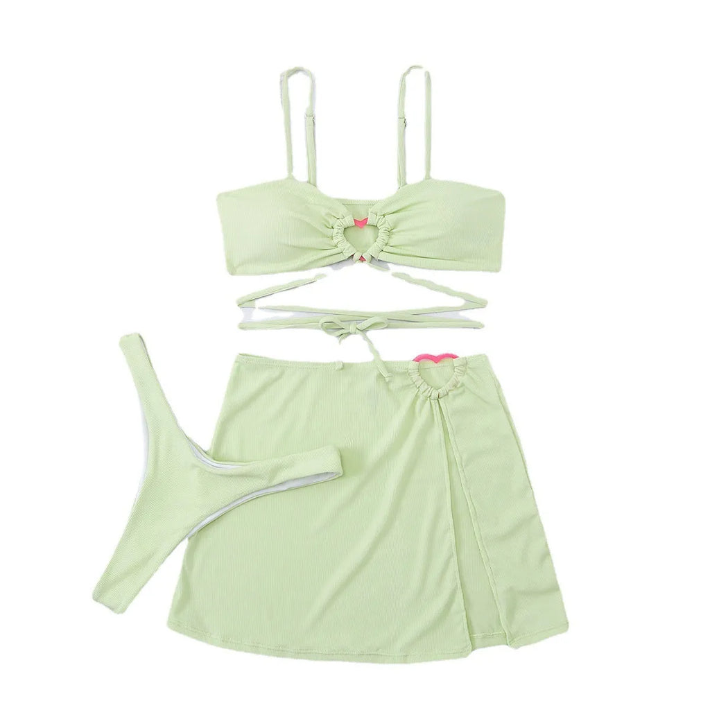 Three-piece women's bikini swimsuit with lace heart design in fruit green colour, shown on mannequin
