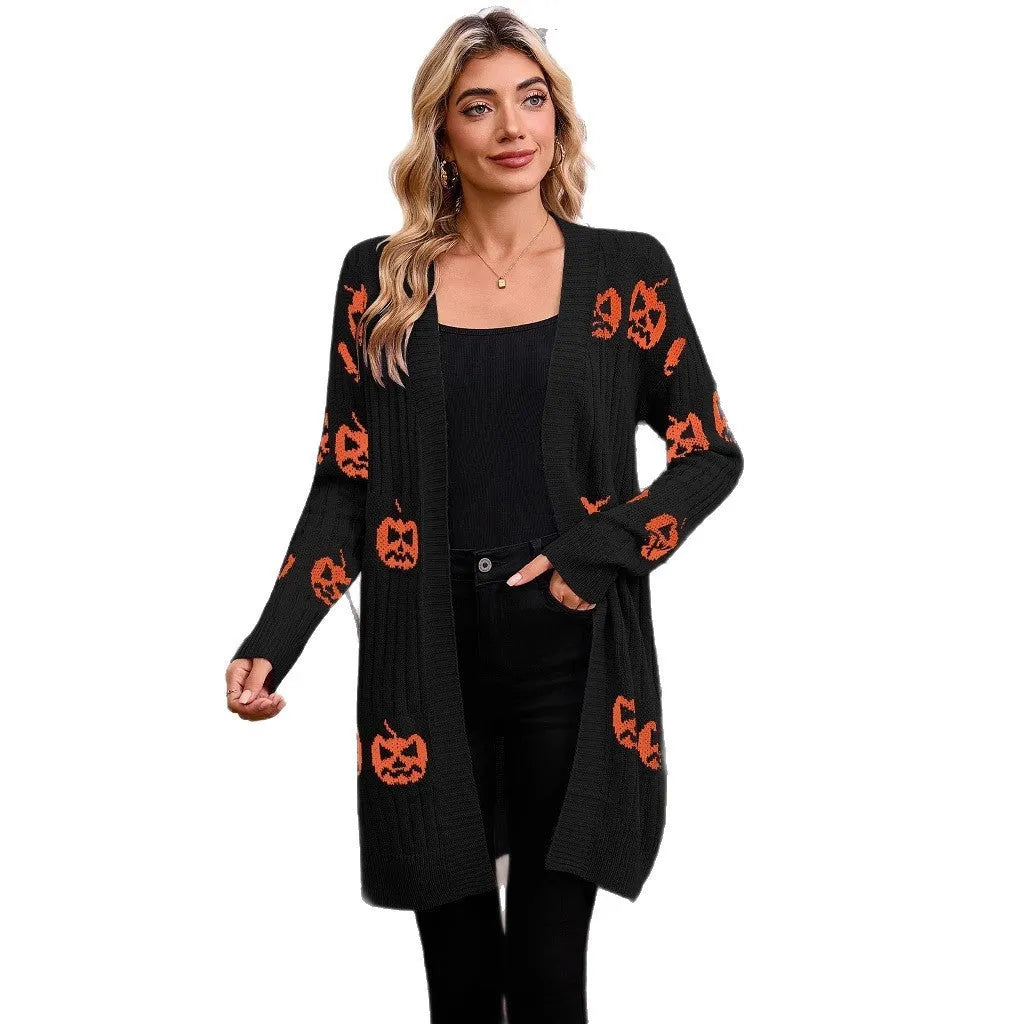 Women's black knitted cardigan with an orange jacquard pumpkin head pattern on the front.