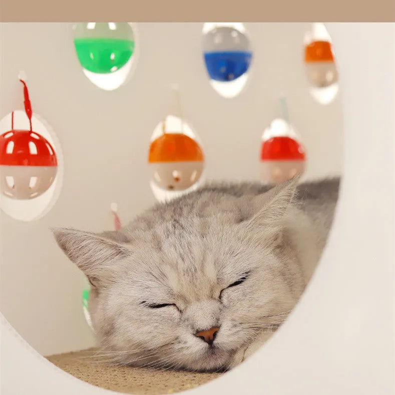 White plastic cat scratch board with integrated enclosed nest, tunnel, and hanging bell ball toy.
