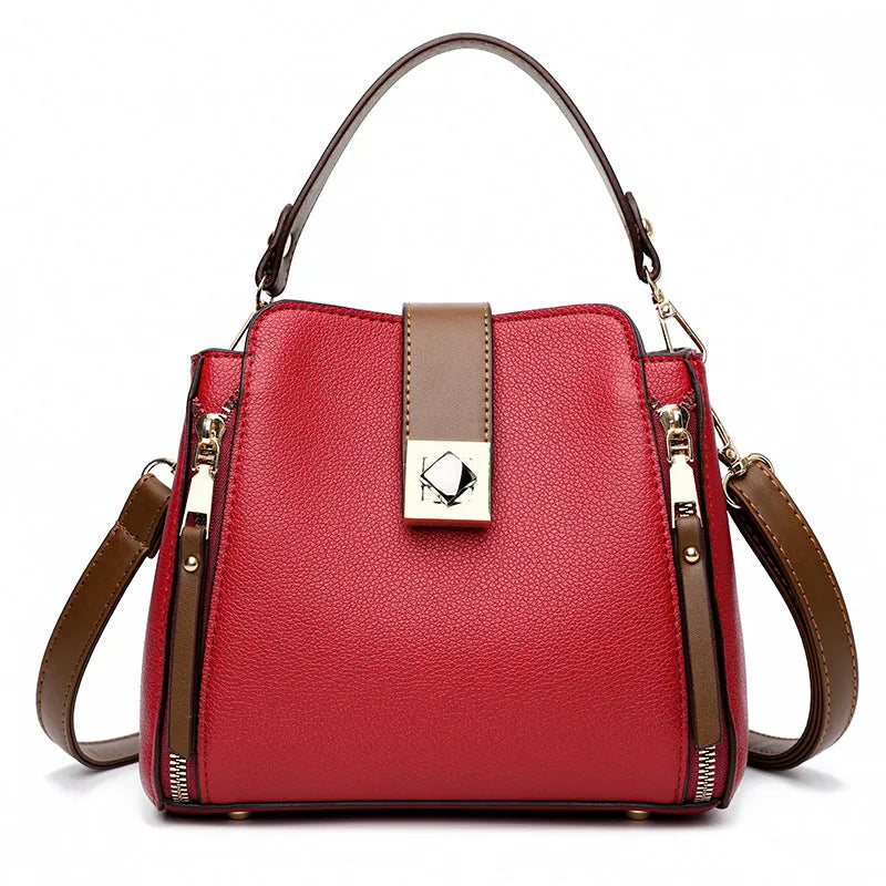 Women's large-capacity PU crossbody bucket bag with three-dimensional outer pocket and splicing detail, shown in black, red, or blue