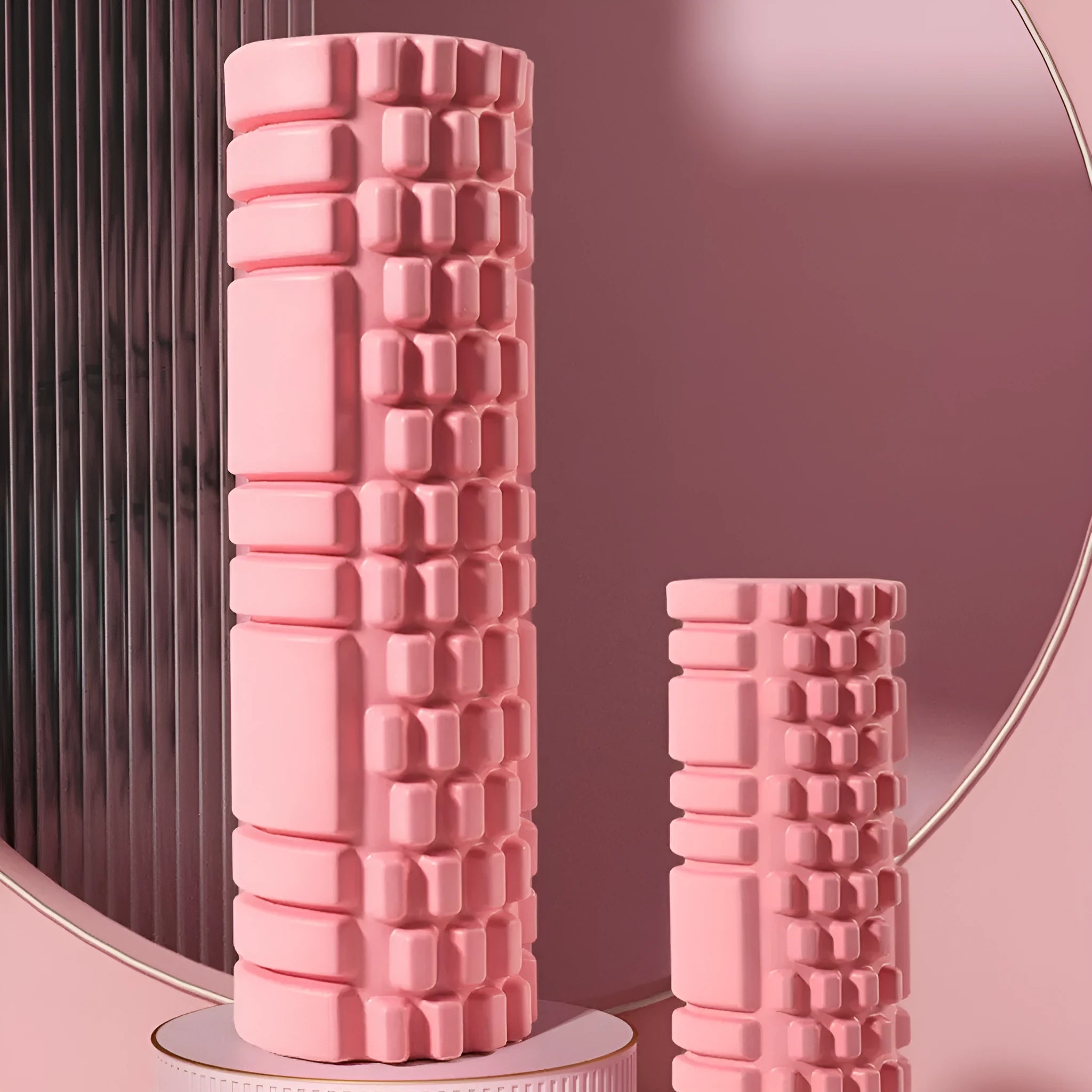 A solid black EVA foam roller on a gym floor, showing its cylindrical shape and texture.
