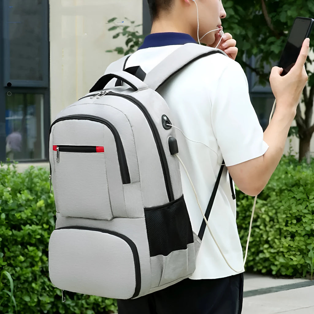 Light grey insulated Oxford cloth backpack with curved shoulder straps and multiple compartments.