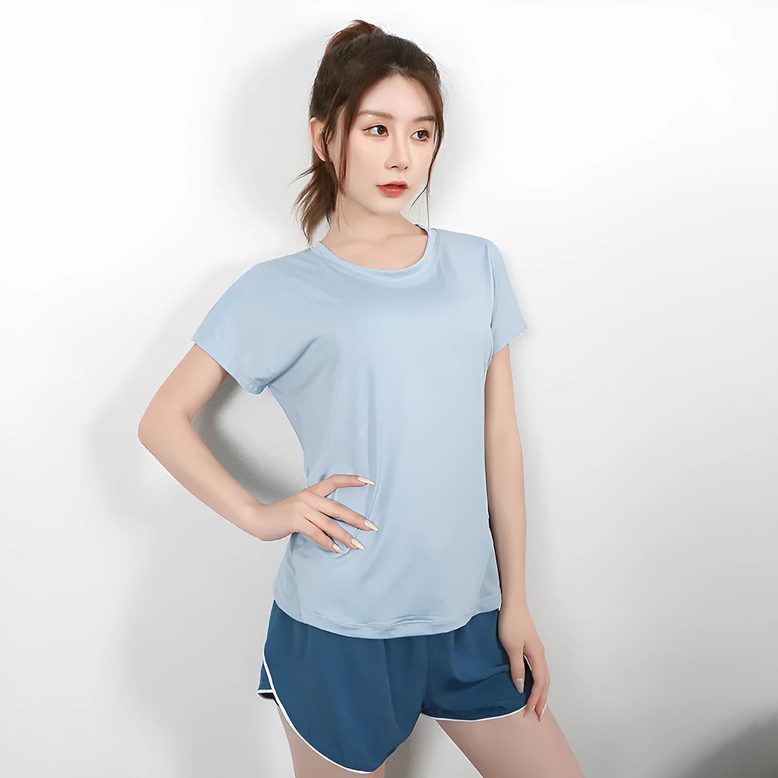 Women's short sleeve polyester sports t-shirt in pink, shown for fitness and leisure wear.