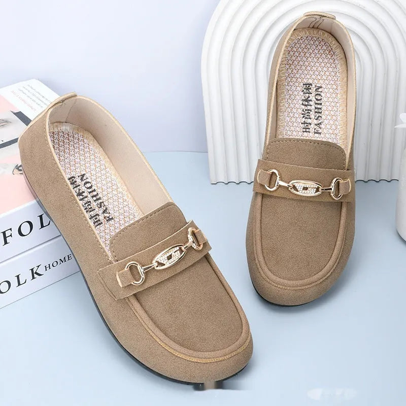 Women's black matte slip-on casual shoes with a round toe and soft rubber sole on a flat surface.