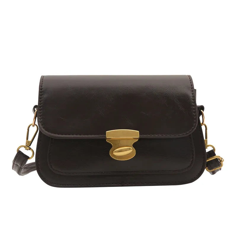 Retro-style small square handbag in soft brown PU leather with a horizontal silhouette.