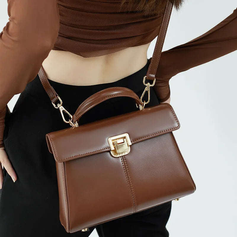 Black genuine leather women's shoulder bag with a front clasp, shown with a detailed view of the internal zip pocket.