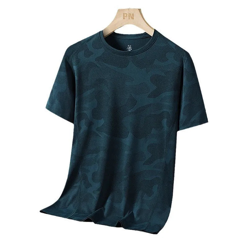 Man wearing a loose fit camouflage pattern short sleeve nylon t-shirt in Army Green.
