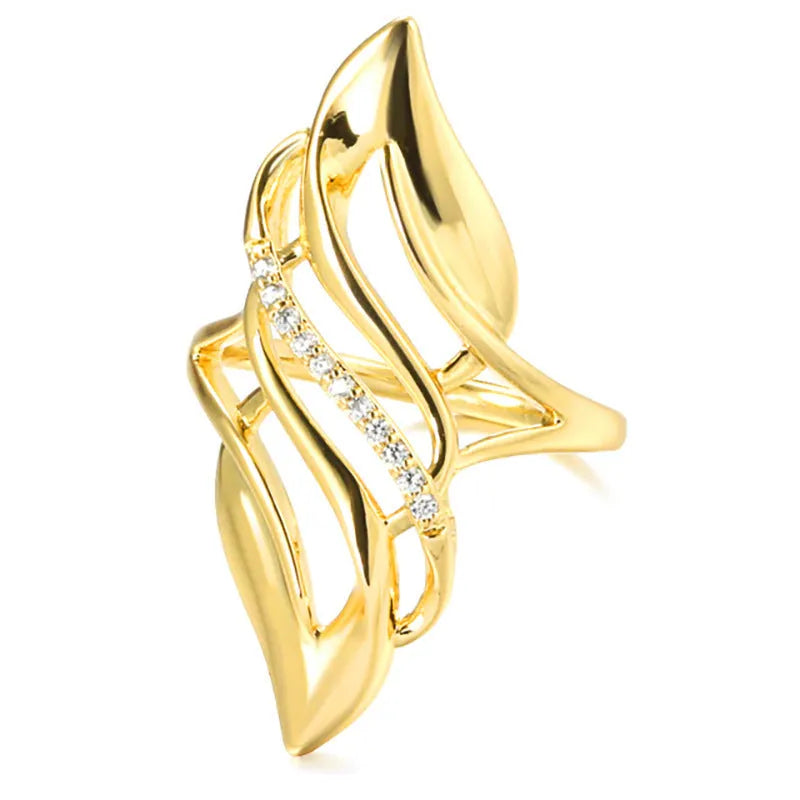 Gold coloured women's ring with an exaggerated curved design on a copper band.