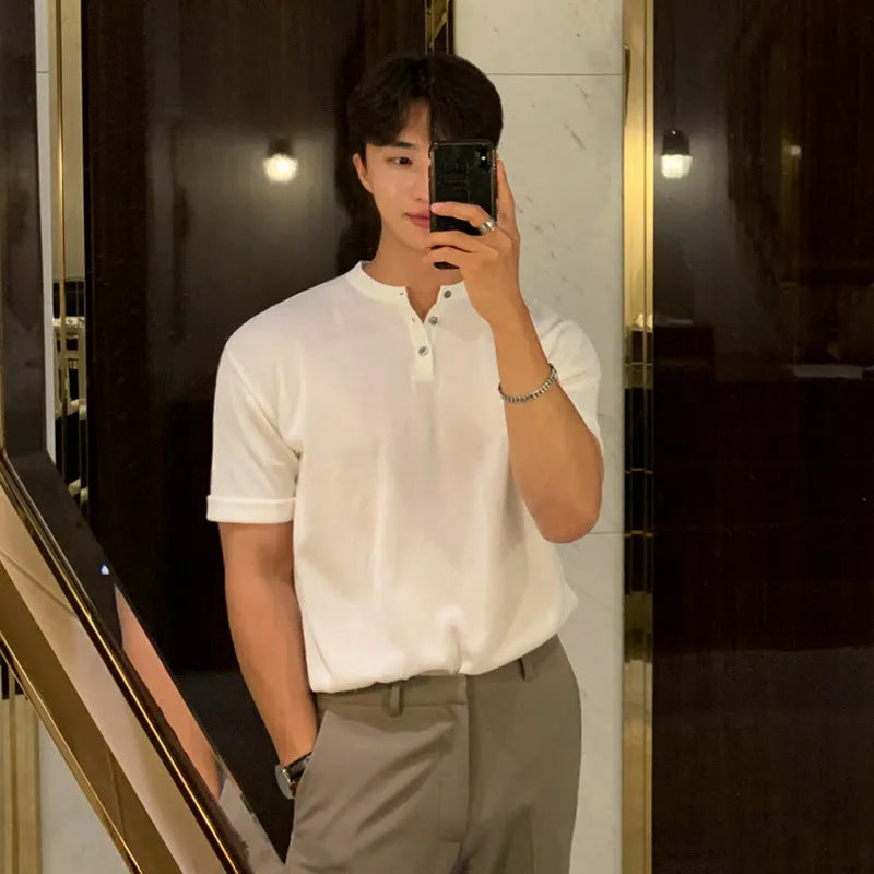 Man wearing a thin black short-sleeved knitted slim-fit pullover shirt.