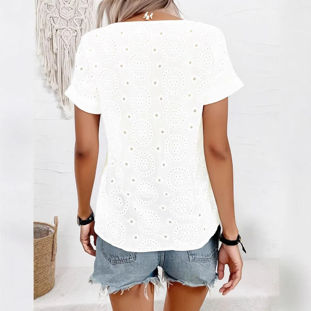 White women's V-neck t-shirt with a hollow-out pattern on the front, showing a loose, casual fit.