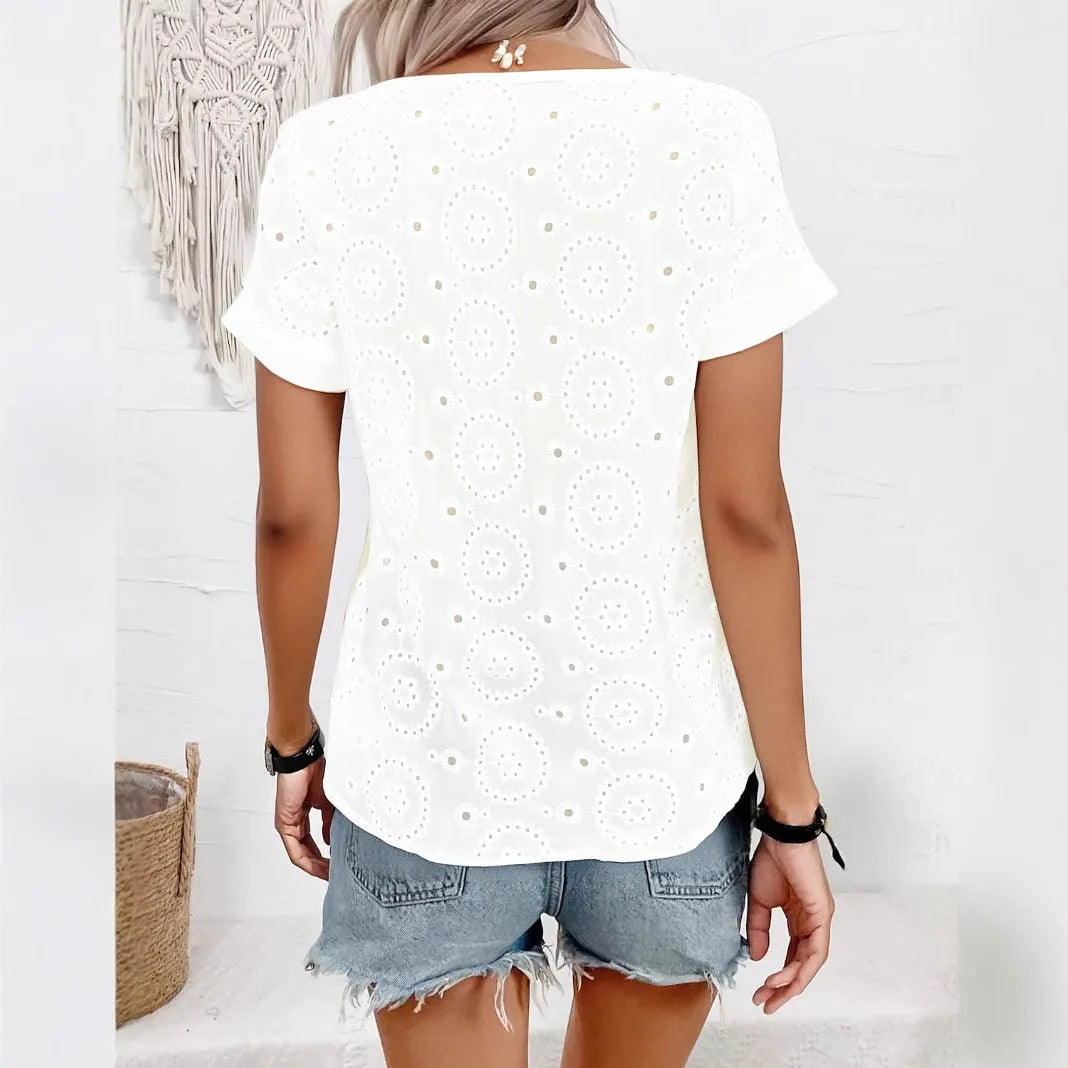 White women's V-neck t-shirt with a hollow-out pattern on the front, showing a loose, casual fit.