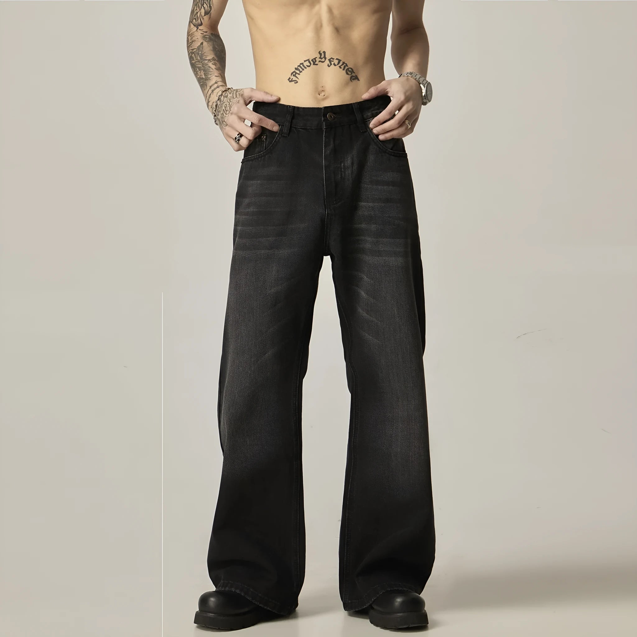 Black straight-leg jeans with retro styling and loose fit on man