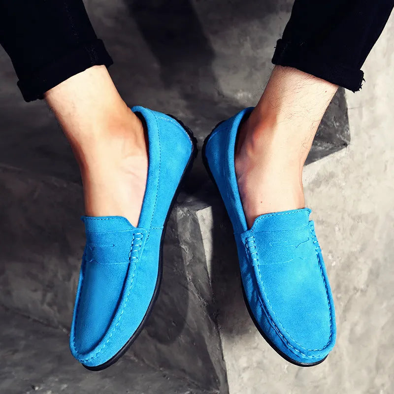 Men's brown suede Gommino-style low-top casual shoes with a round toe and flat rubber sole.