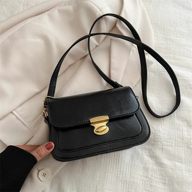 Retro-style small square handbag in soft brown PU leather with a horizontal silhouette.