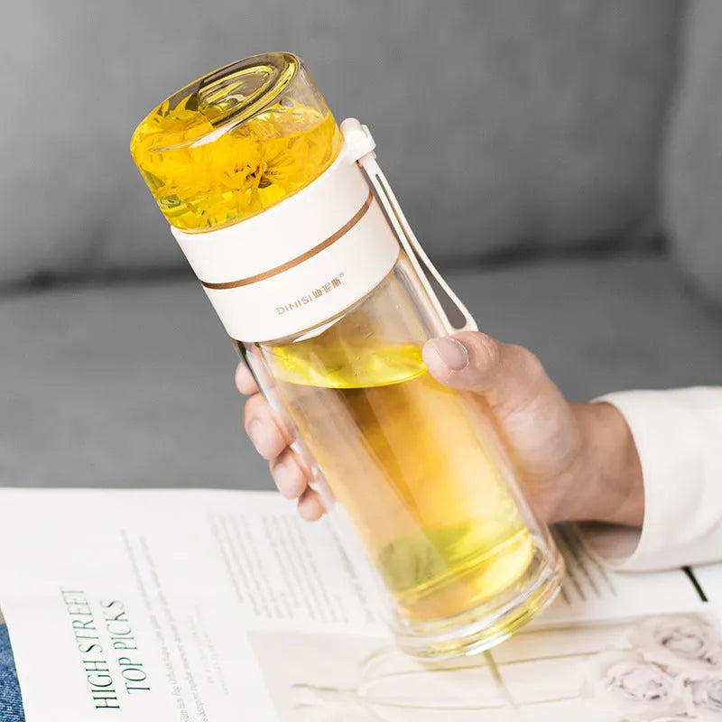 Double-wall glass water bottle with tea infuser insert and rope handle in assorted colours.