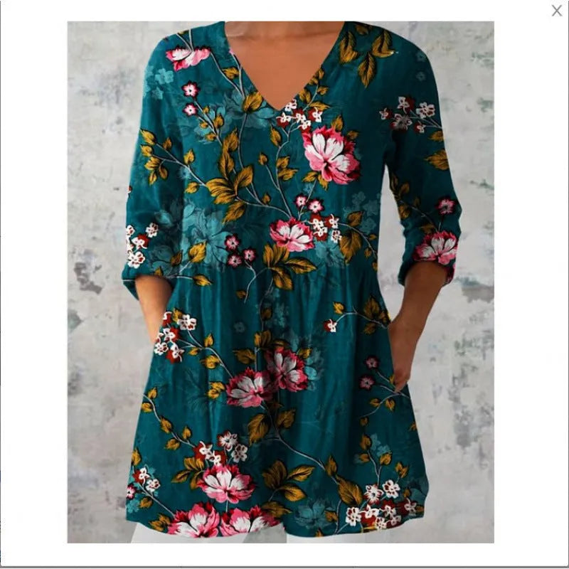 A woman modelling a loose-fitting, printed wave-pattern dress with 3/4 sleeves.