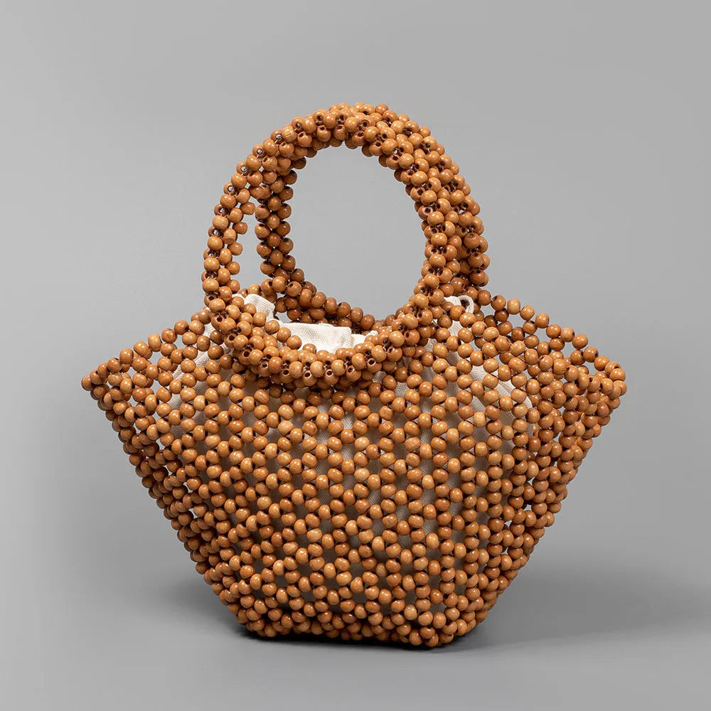 Hand-woven maple wood hollow handbag with wooden bead decoration in dumpling shape