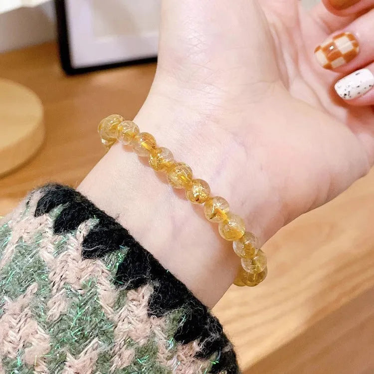 Gold rutilated quartz and sunstone crystal bracelet with diamond beads on adjustable band