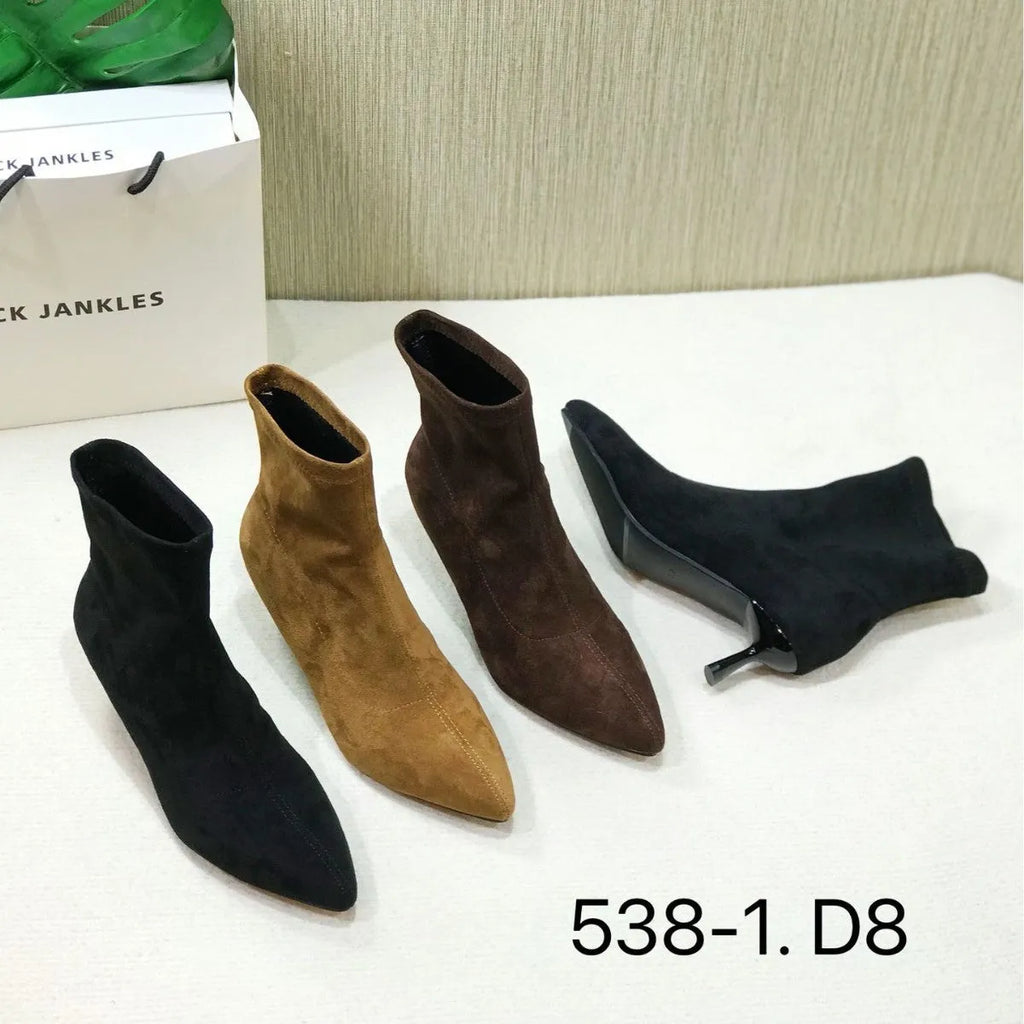 Black pointed toe women's ankle boot with a stiletto heel on a plain background.